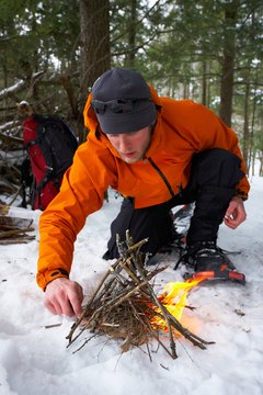 Backpacker starting fire in snow