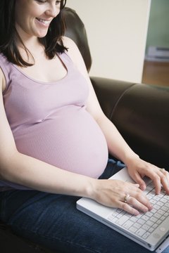 Pregnant woman using laptop computer