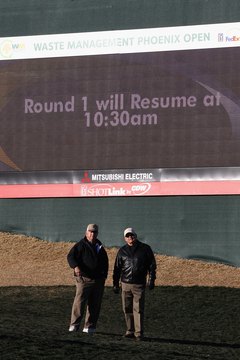 Spectators wait out a frost delay during the 2011 Waste Management Phoenix Open.