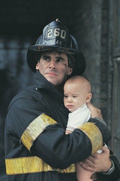 Firefighter rescuing baby