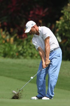 PGA Tour player Jonathan Byrd always keeps his upper arms close to his body, which keeps his swing more compact.