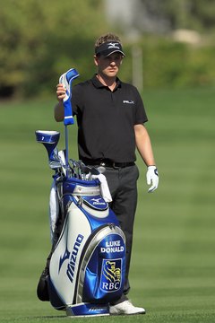 PGA Tour pro Luke Donald selects a 3-wood for his fairway shot.