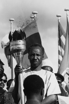 Nyerere is presented the torch of freedom by Tanzania's youths in 1966.