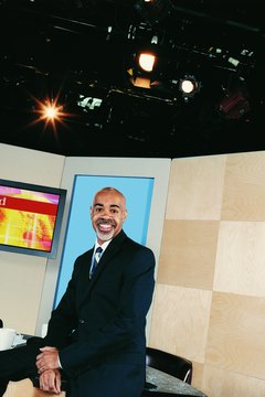 TV Presenter Sitting on a Desk in a TV Studio