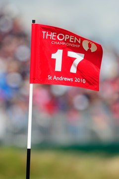 Red flags fly on the shared greens of the back nine holes at St. Andrews Old Course.