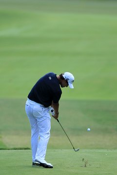 Adam Scott positions his ball so he always hits it just before he takes a divot.