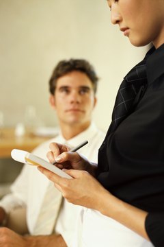 waitress taking order from a businessman