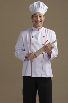 Chinese chef holding rolling pin, portrait