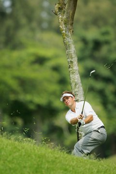 Nick Dougherty makes a flat swing to keep the ball below a tree branch.