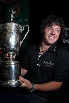 U.S. Open champion Rory McIlroy of Northern Ireland proudly holds the trophy for winning in 2011.