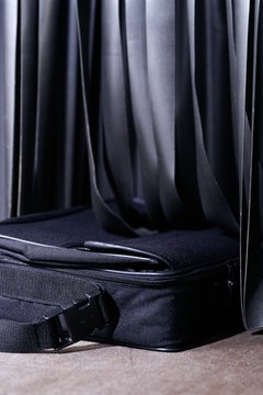 Suitcase on conveyor belt entering airport X-ray machine