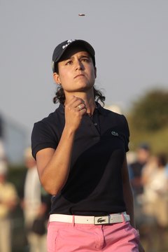Lorena Ochoa flips a ball marker in the air before putting.