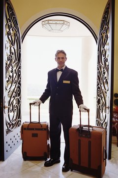 Hotel attendant carrying luggage, portrait