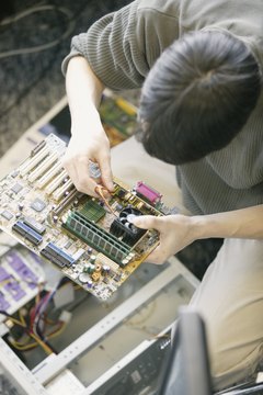 Computer technician fixing circuit board
