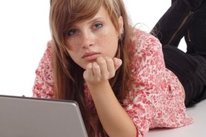 typing girl image by Andrey Kiselev from Fotolia.com To