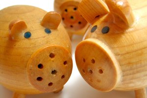 three wooden pigs image by Angel_a from Fotolia.com "The