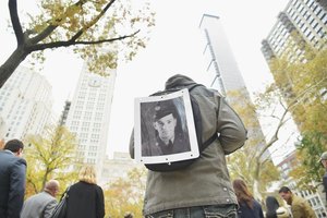 Michael Loccisano/Getty Images News/Getty Images A parade attendee on Veteran's Day exhibiting a portrait of his grandfather who served in the military.