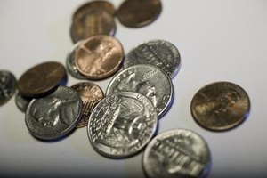 Photodisc/Photodisc/Getty Images It is not unusual to find coins on the headstones of soldiers, such as these at Arlington National Cemetery.