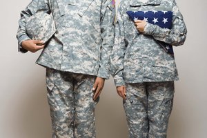 Soldiers standing with folded American flag