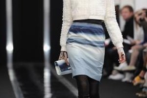 Pascal Le Segretain/Getty Images Entertainment/Getty Images A model walks the runway in a pencil skirt and knee-high boots at the Maxime Simoens Fall/Winter preview during Paris Fashion Week in 2013.