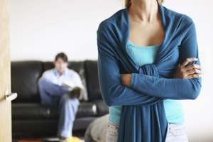 Woman angry with man sitting on couch