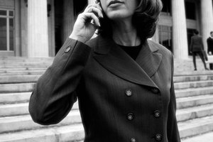 black and white portrait of a young businesswoman talking on a mobile phone