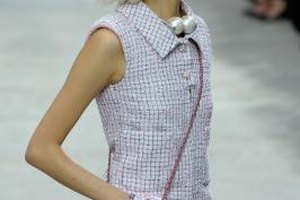 Pascal Le Segretain/Getty Images Entertainment/Getty Images Chanel is known for its haute couture, like this dress and handbag modeled during Paris Fashion Week in October 2013.