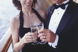 Steve Mason/Photodisc/Getty Images A summer black-tie event might mean a sleeveless cocktail dress for women, and a lightweight tuxedo for men.