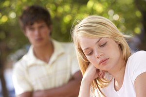 Unhappy teenage girl with boyfriend