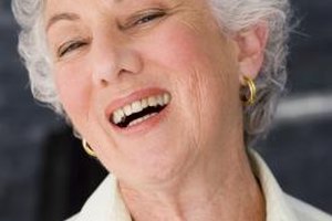 Jupiterimages/Pixland/Getty Images Applying blush to the apples of your cheeks can help prevent your white hair from making you look washed out.