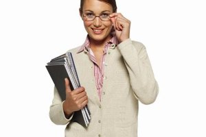 George Doyle & Ciaran Griffin/Stockbyte/Getty Images Dressing a step or two above typical teacher attire is generally acceptable for a teaching interview.