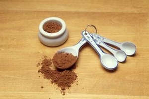 Jupiterimages/Stockbyte/Getty Images Adding cocoa powder to a recipe without making changes to the amount of flour can result in dry cakes.