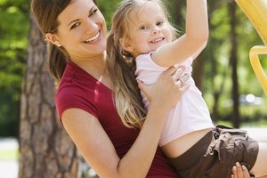 Smiling mother and daughter playing