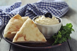 Hummus con pedazos de pan pita.