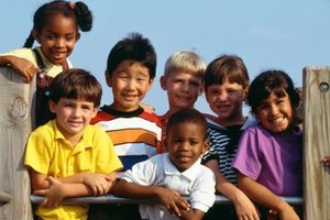 Jupiterimages/Photos.com/Getty Images Factors affecting middle childhood development include genetics, iron deficiency, disabilities and hormones.
