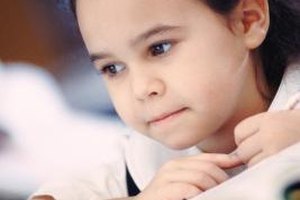 Stockbyte/Stockbyte/Getty Images The Dominie Reading and Writing Assessment Portfolio helps teachers assess students' progress in reading.