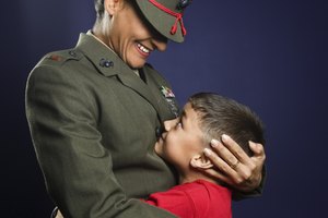 United States Marine hugging son