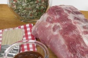Jupiterimages/liquidlibrary/Getty Images Once you've seasoned and sliced the meat you're using to make jerky, brush it with the barbecue sauce to ensure it's evenly coated.