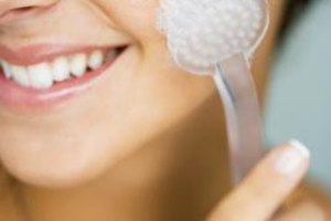 Jupiterimages/Pixland/Getty Images Exfoliating no more than three times a week can enhance your natural beauty, combatting breakouts and oiliness.