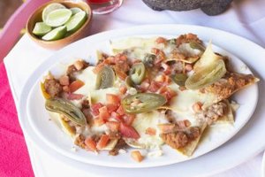 Jack Hollingsworth/Photodisc/Getty Images Substitute spring roll wrapper chips in lieu of tortilla chips for a unique spin on traditional nachos.