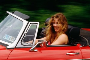 Woman driving red convertible