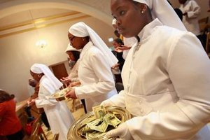 Scott Olson/Getty Images News/Getty Images Nation of Islam followers collect the offering after a speech by Louis Farrakhan at the Mosque Maryam in Chicago.a.