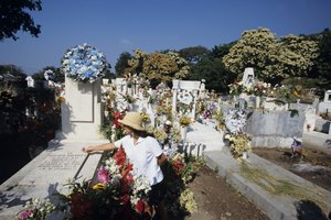 Permite que tus hijos ayuden a decorar la tumba del padre fallecido.