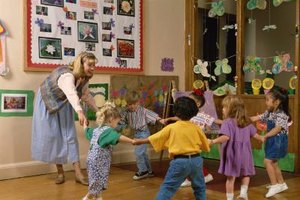 Jupiterimages/Photos.com/Getty Images An engaging and interactive kindergarten teacher will likely create a positive learning environment.