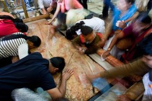 Uriel Sinai/Getty Images News/Getty Images Pilgrims kiss the stone slab where the body of Jesus was anointed before burial at the Church of the Holy Sepulchre in Jersualem.