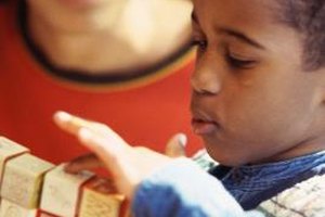 Stockbyte/Stockbyte/Getty Images Spatial awareness, creativity, language and geometry are some of the many learning areas promoted by block play.