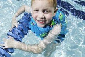 Photodisc/Photodisc/Getty Images Most swimsuits that help your child float are swim aids rather than personal floatation devices and should only be used under close adult supervision.