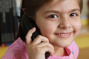 Visage/Stockbyte/Getty Images Children often possess a strong curiosity about talking on the telephone and answering the front door.
