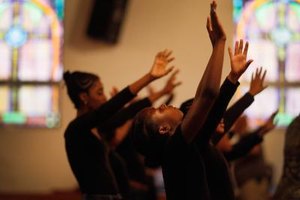 Joe Raedle/Getty Images News/Getty Images Praise dance can express community emotions, such as at this prayer service for Trayvon Martin at Allen Chapel A.M.E. Church in Florida.