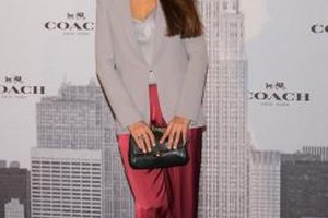Carlos Alvarez/Getty Images Entertainment/Getty Images Spanish actress Monica Estarreado wears red satin pants with a gray top and blazer at Madrid's Coach grand opening in 2013.